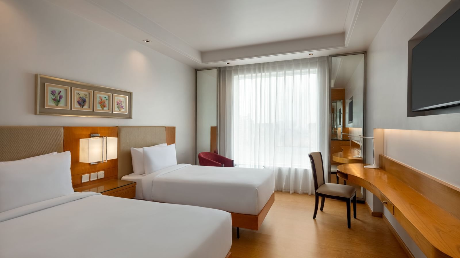 Standard guest room with twin beds and modern amenities at Ramada by Wyndham Ghaziabad Vasundhara