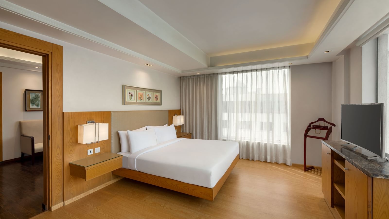  Guest room with modern furnishings and city view at Ramada by Wyndham Ghaziabad Vasundhara