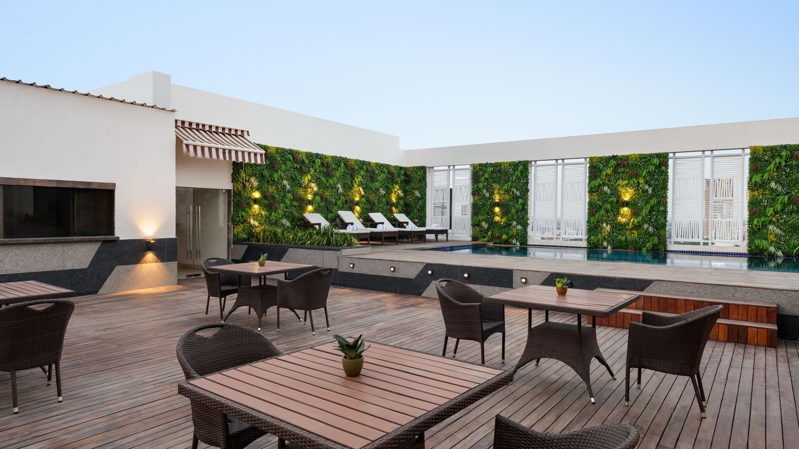 Rooftop terrace dining area with outdoor seating and city views at Ramada by Wyndham Ghaziabad Vasundhara