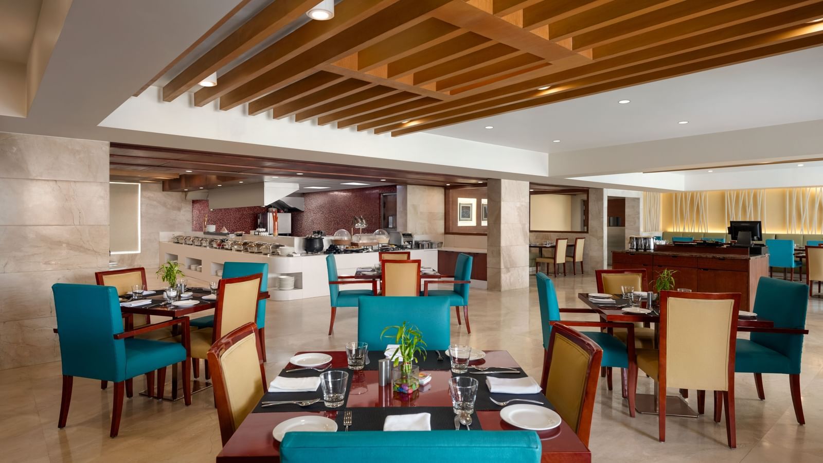 Meeting room with turquoise chairs and wooden ceiling details at Ramada by Wyndham Ghaziabad Vasundhara