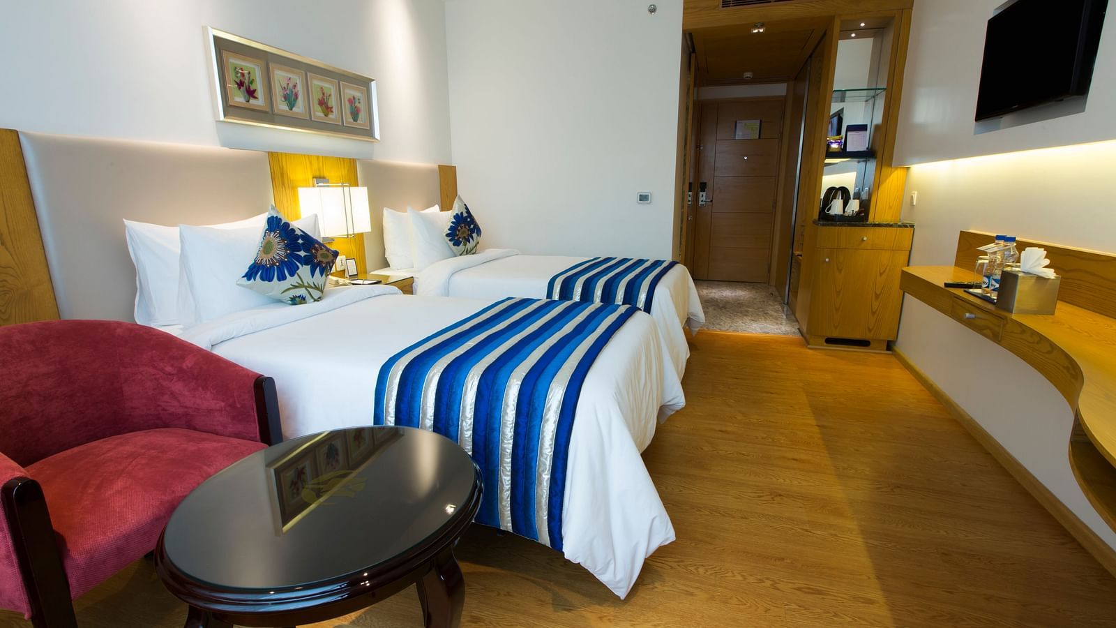 A room featuring two cosy single beds with a bed side table in the middle - Ramada by Wyndham, Ghaziabad, Vasundhara