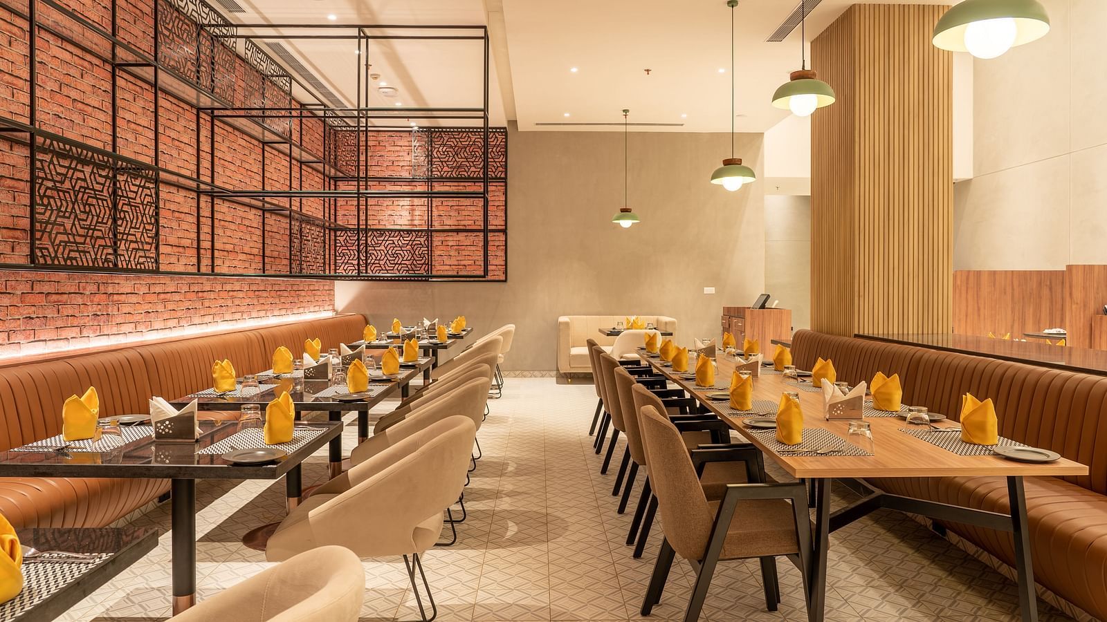 Dining setting with cutlery on a table at Ramada Encore, Bhiwadi.