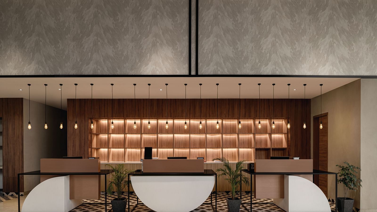 Ramada Encore by Wyndham, Bhiwadi | Hotel lobby with reception desk, decorative lighting, and seating.