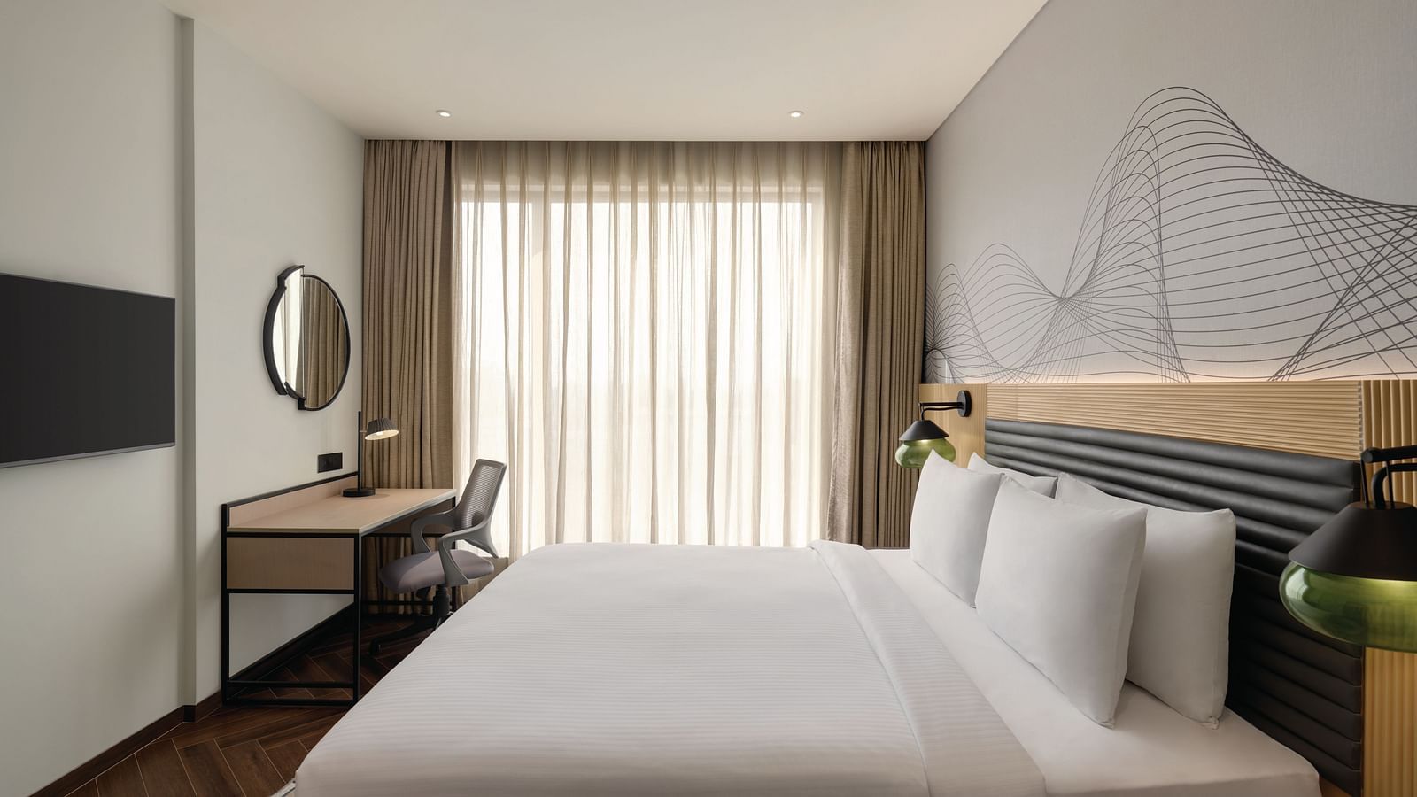 Ramada Encore by Wyndham, Bhiwadi | Hotel bedroom with a striped throw pillow, wooden headboard, and bedside table.