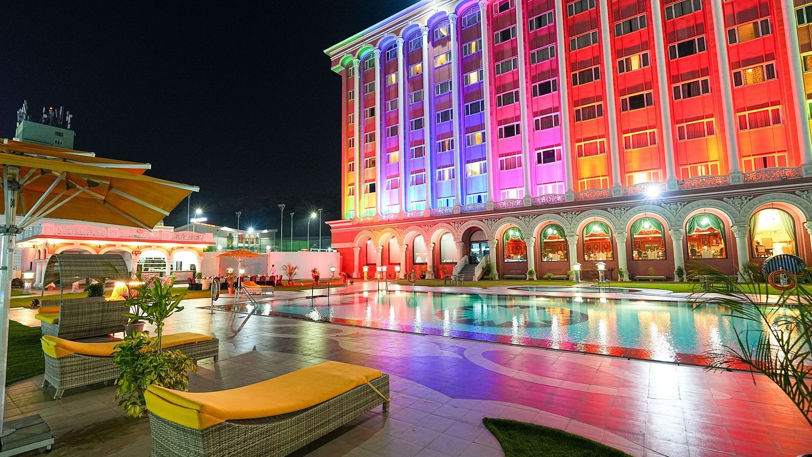 poolside view at Sitara Luxury Hotel featuring ambient lighting at night - Ramoji Film City Hotels in Hyderabad 
