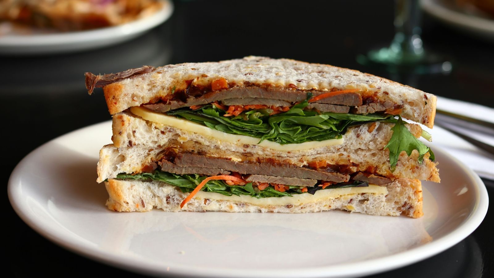 Sandwiches on a plate with cutlery on the side