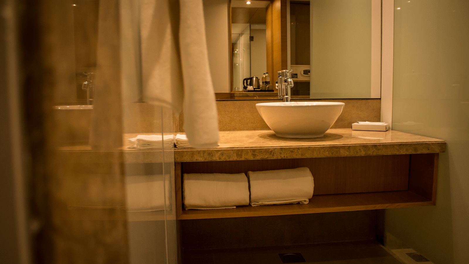 Image of an bathroom with a sink, mirrors  and towels | Regency Tirunelveli By GRT Hotels