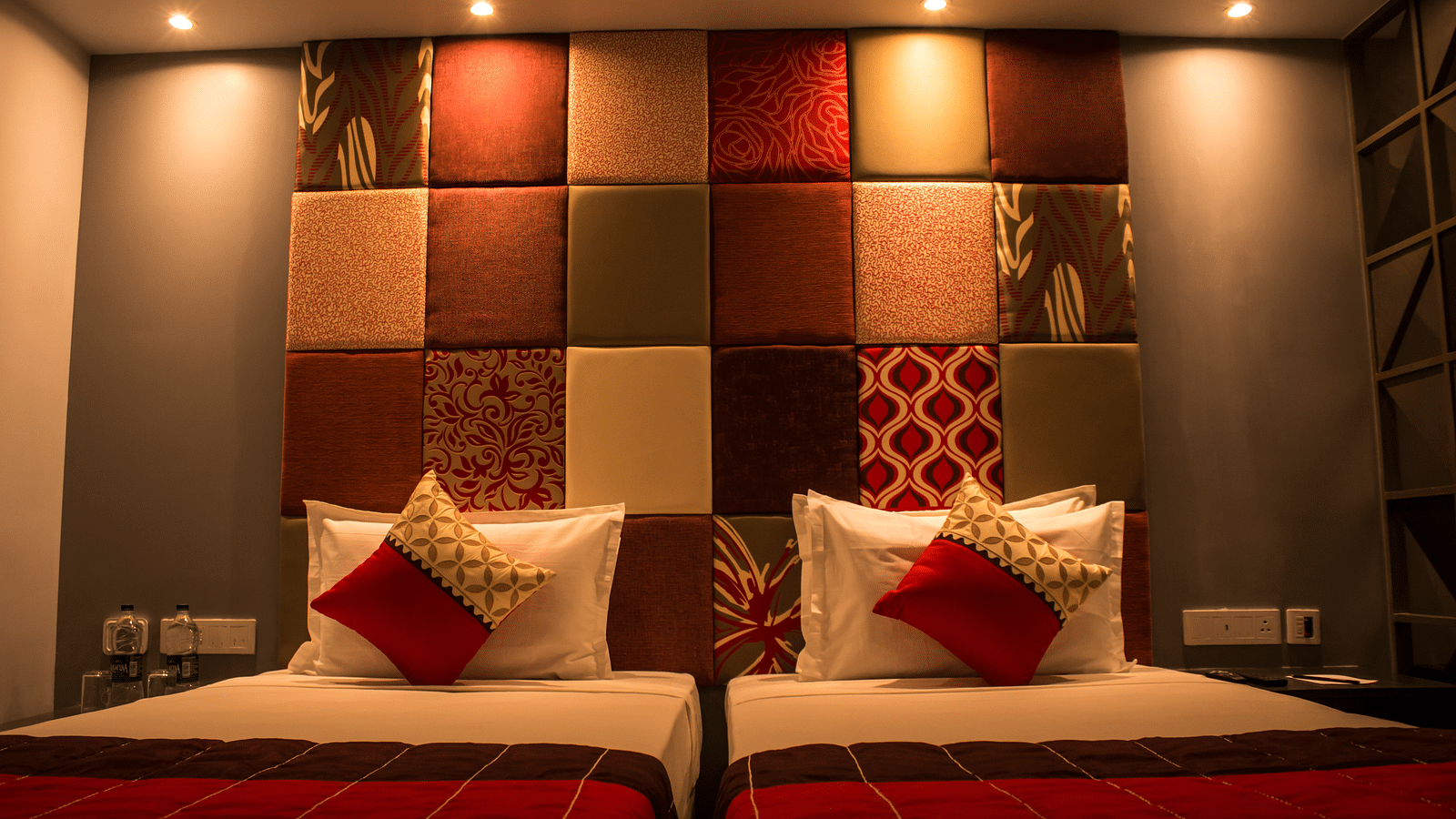 A room with twin beds and  pillows arranged on it  | Regency Tirunelveli By GRT Hotels