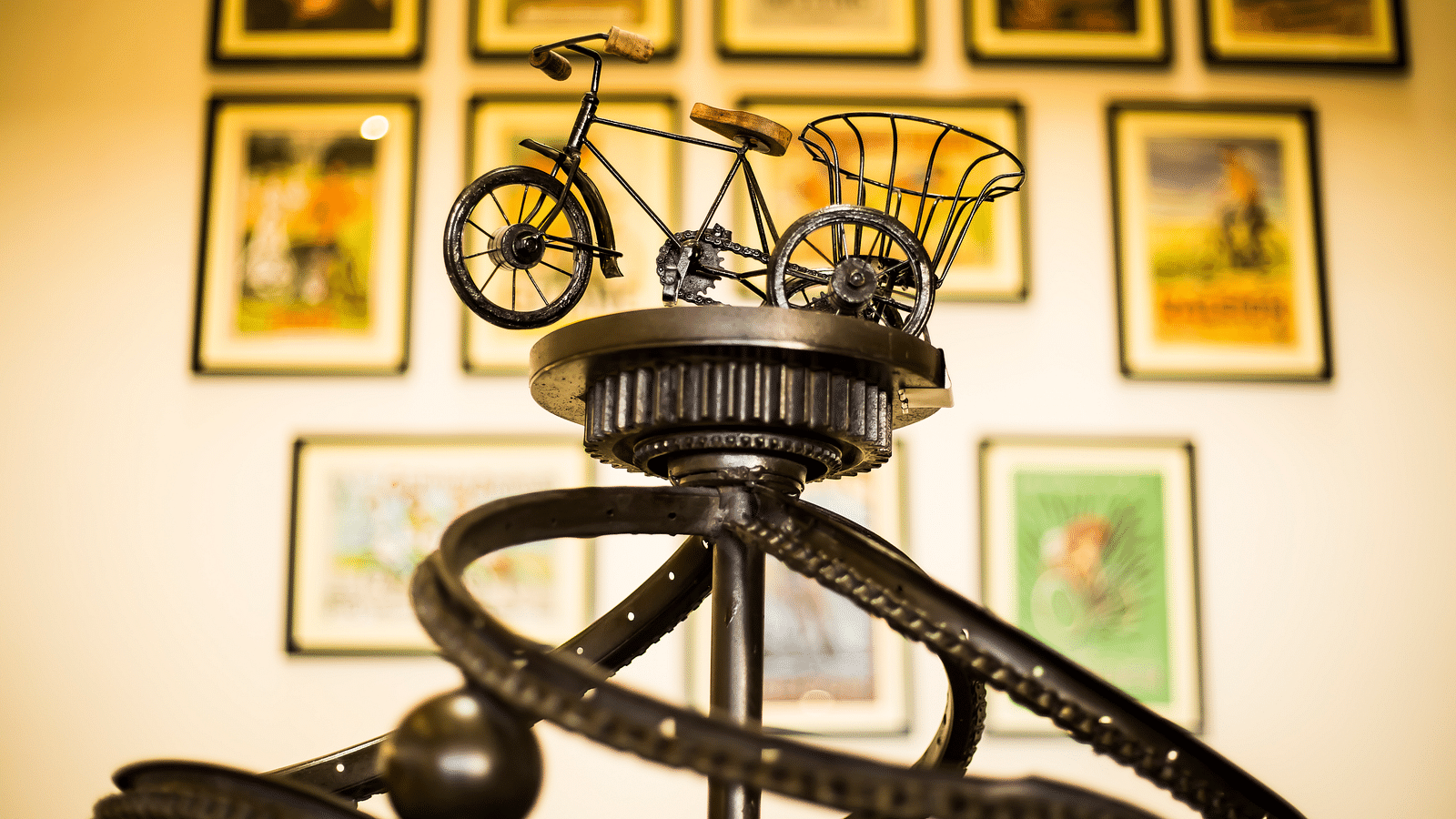 A miniature bicycle rickshaw sculpture on a metal base with gears and a ball | Regency Tirunelveli By GRT Hotels