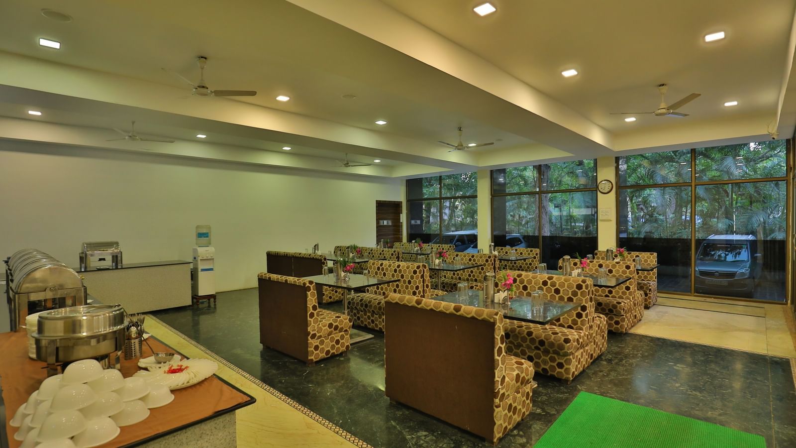A large dining area with various seating areas, including sofas and low tables, and warm lighting - Retreat Heritage, Lonavala
