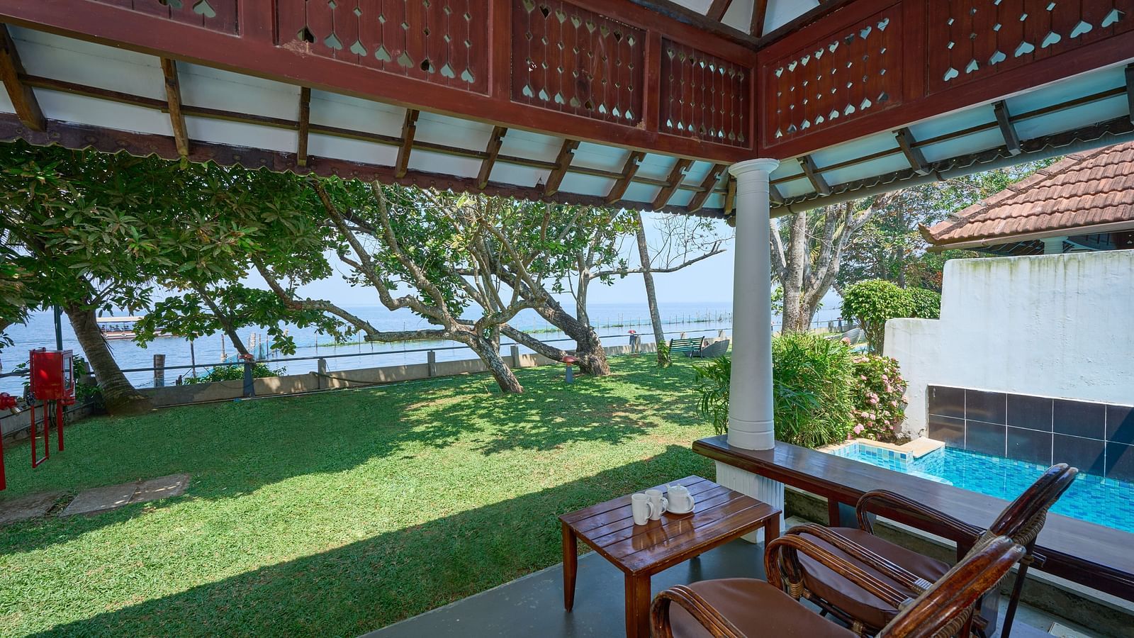 a view from inside a balcony of the garden - Rhythm Kumarakom