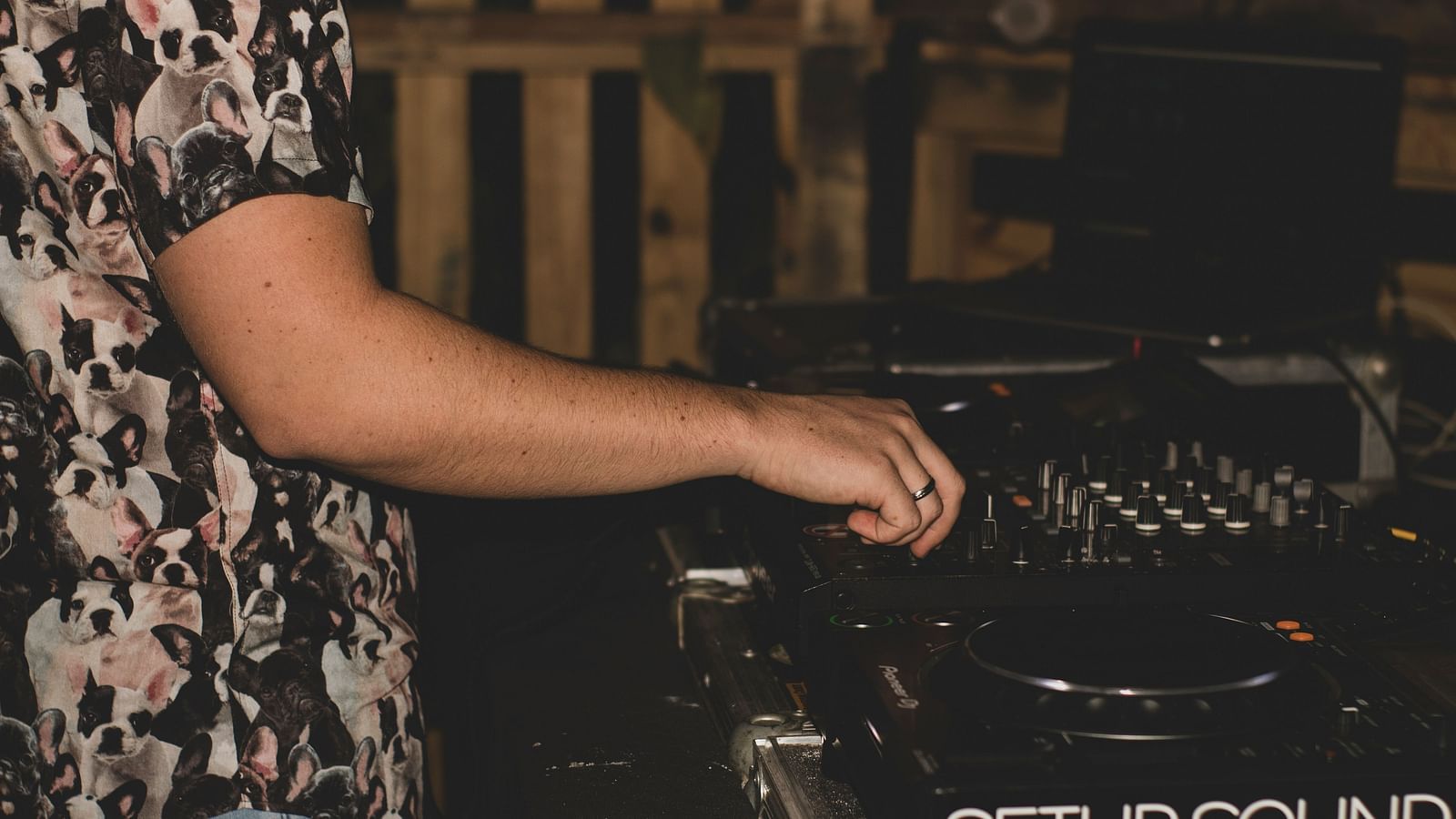 an image of a person playing music with a DJ keyboard