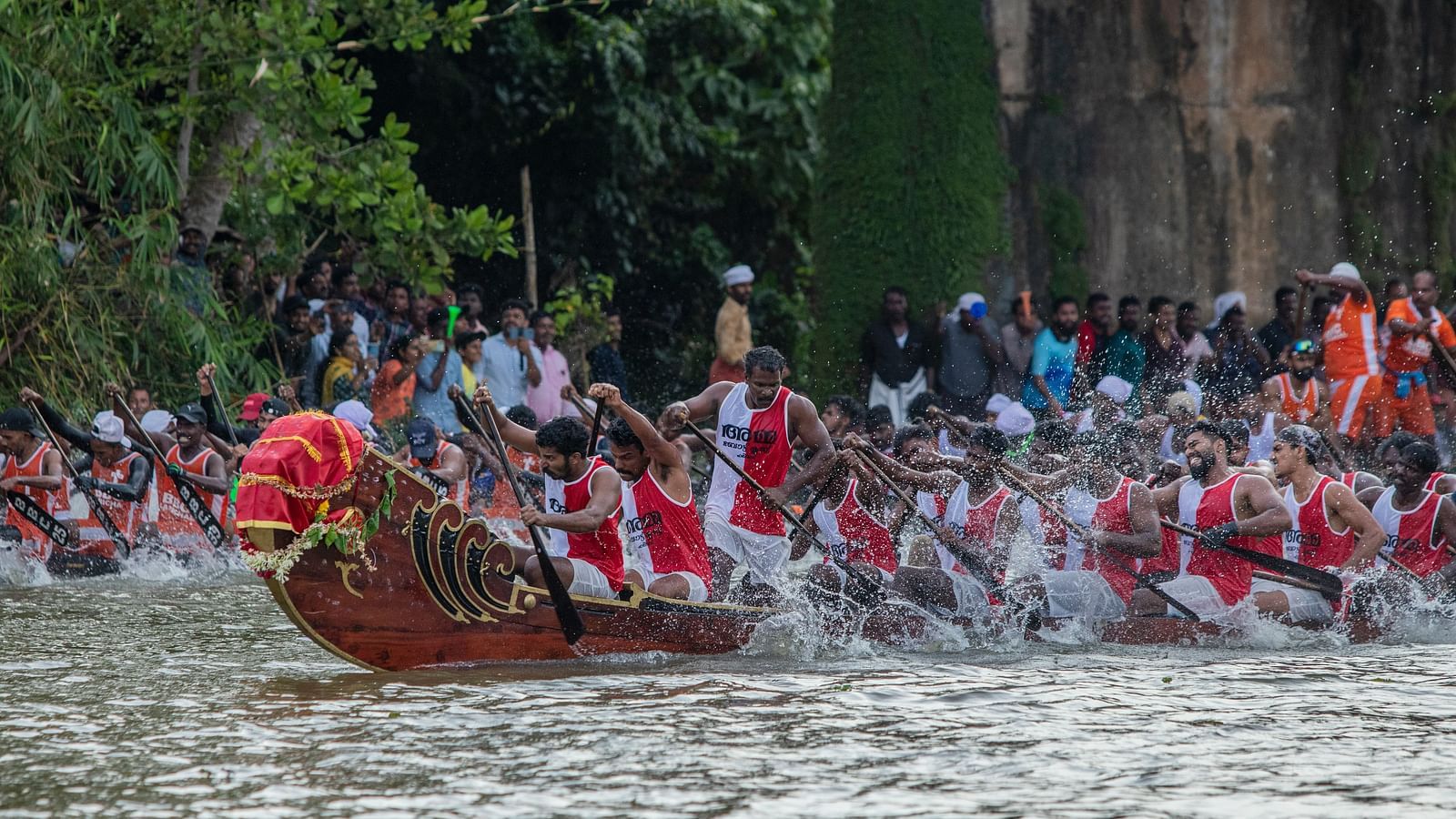 An overview of Kumarakom Boat Race with a boat having people paddling.