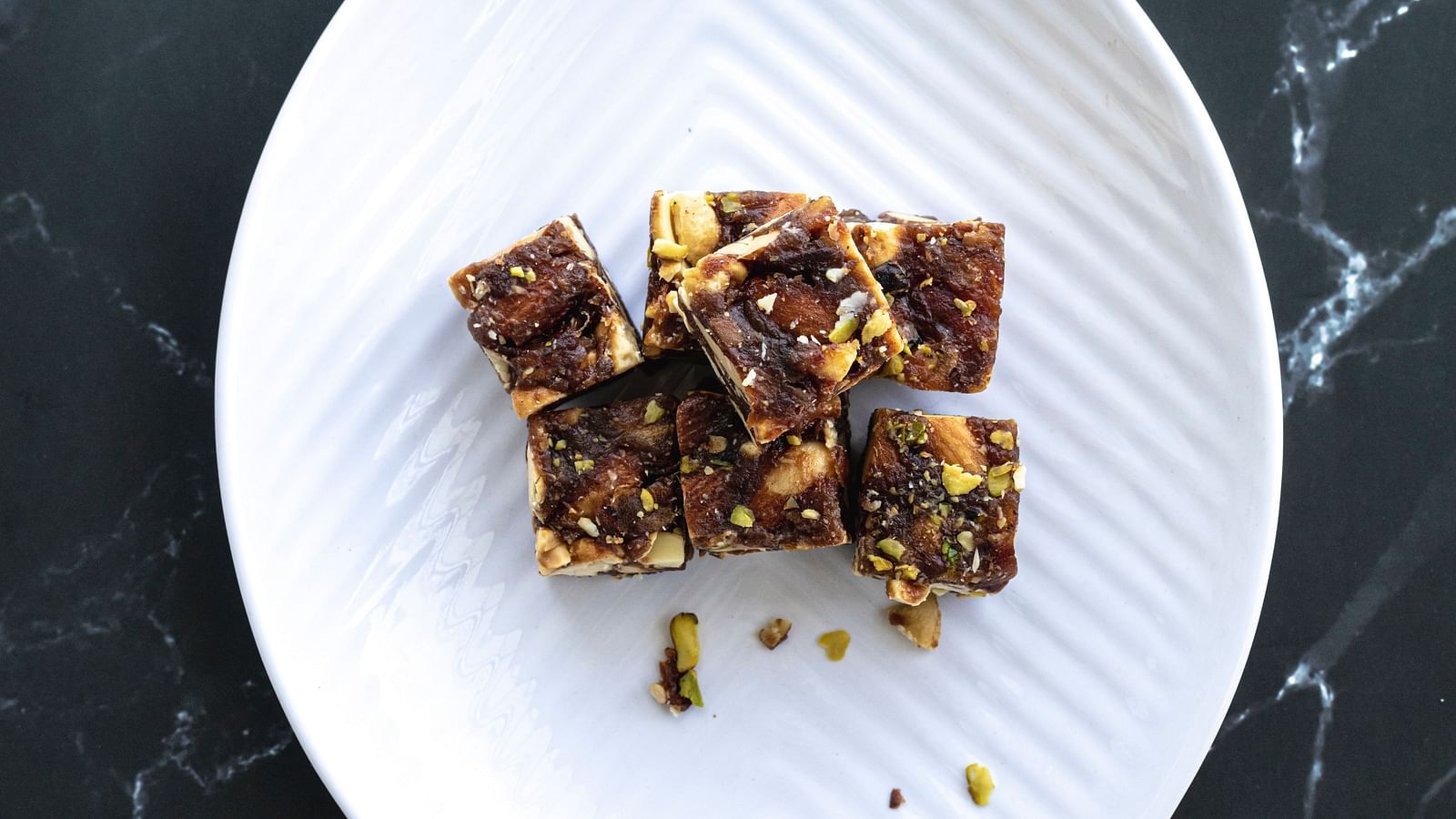 an image of Chikki sweet displayed on a white plate as seen from above.
