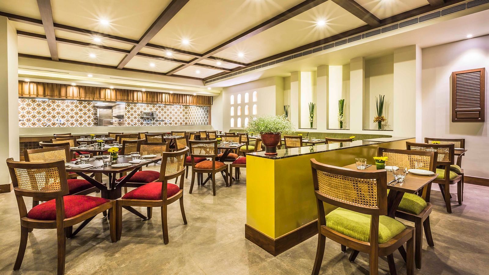 an image of a cosy cafe interiors with colourful chairs at a Lonavala restaurant and bar - Rhythm Lonavala.