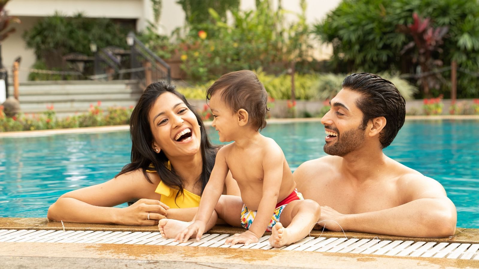 an image of a Parent and kid enjoying the swimming pool