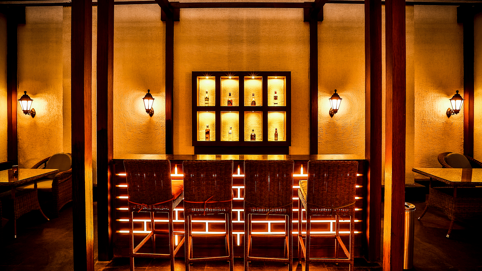 a dining table with chairs below it and a brilliant aesthetic decor at Cedar Lounge bar - Rhythm Lonavala.
