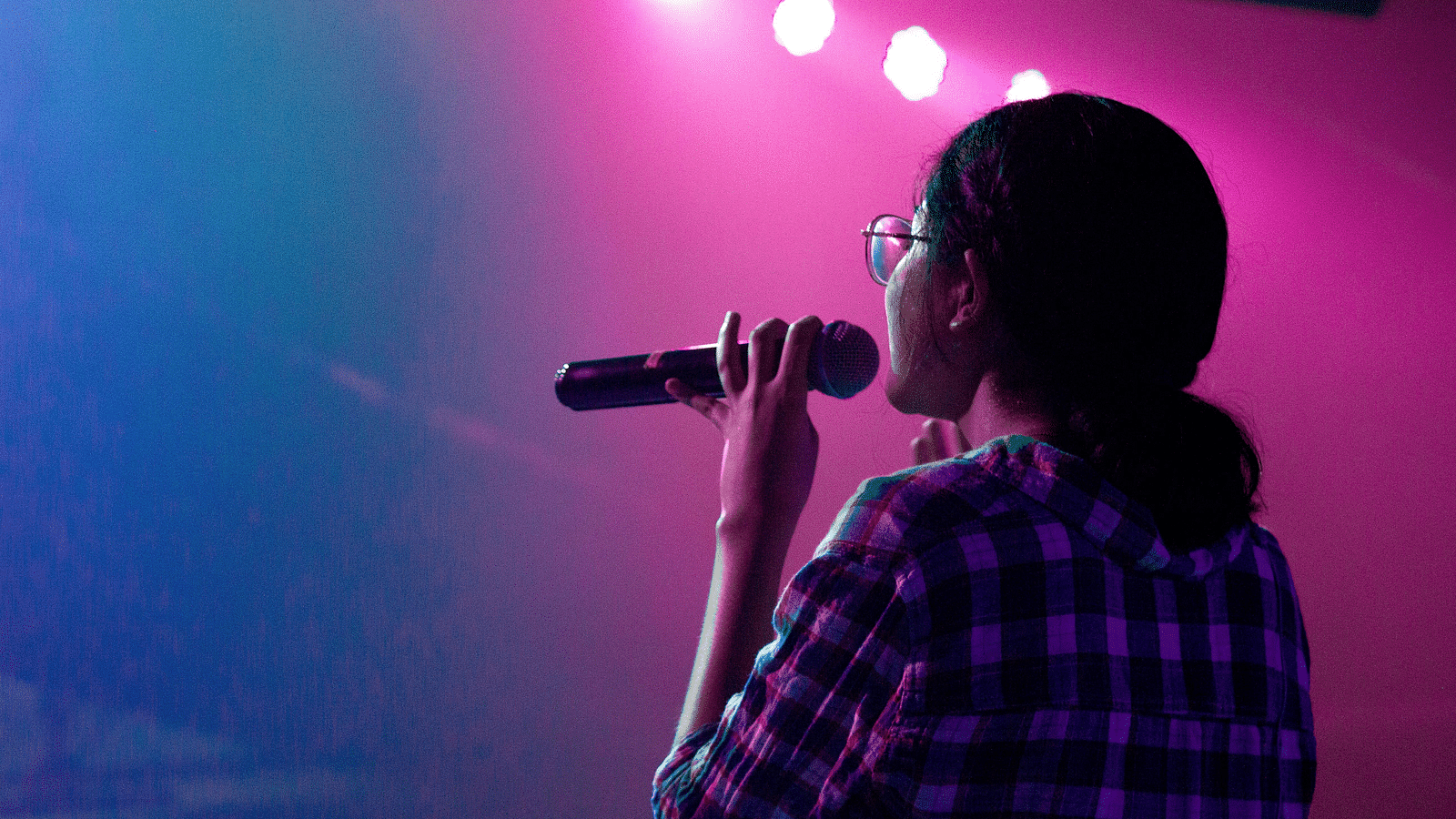 A woman singing karaoke - Best resort in Lonavala for group