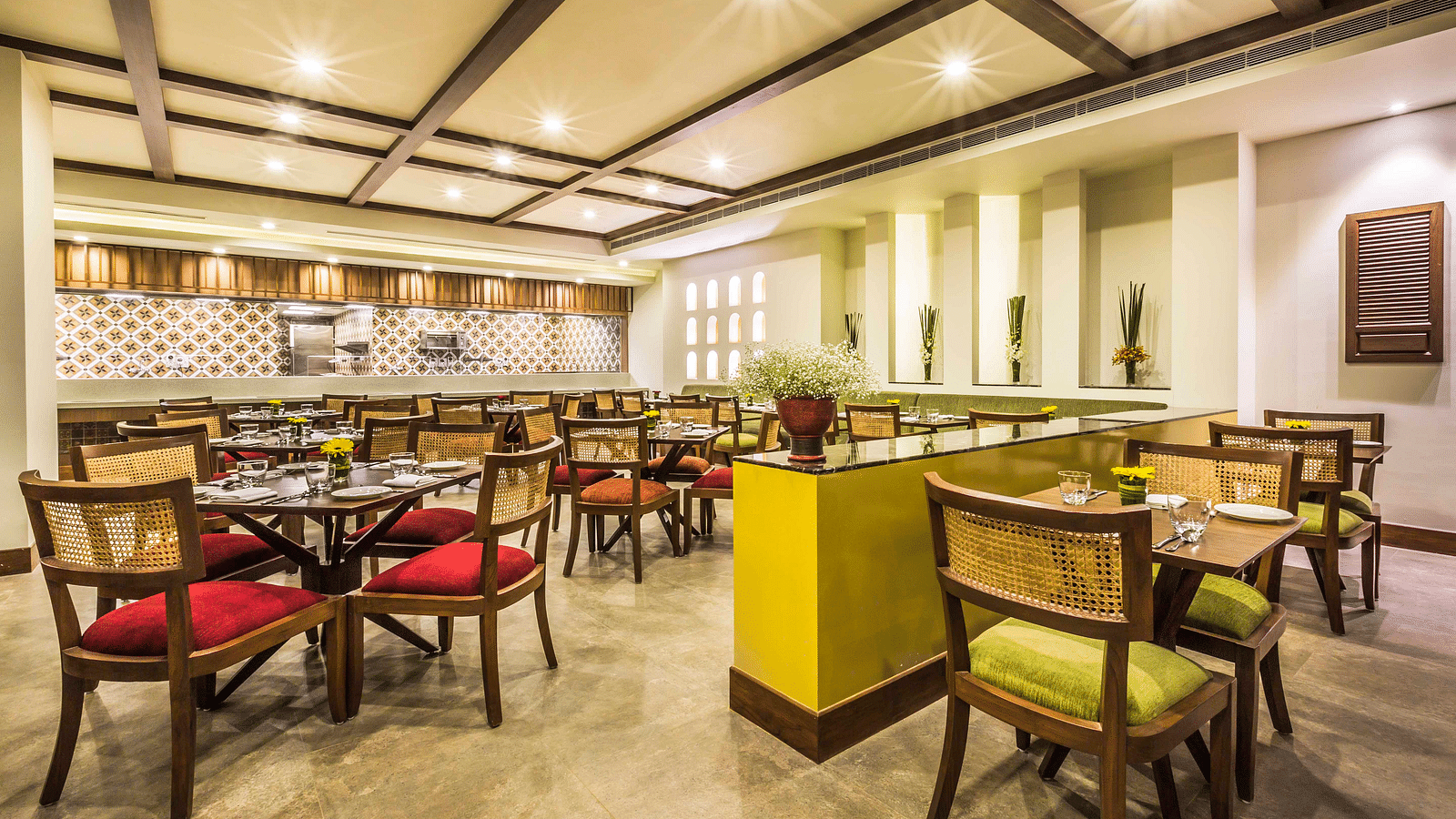 The cafe features cosy interiors with colourful chairs - Rhythm Lonavala