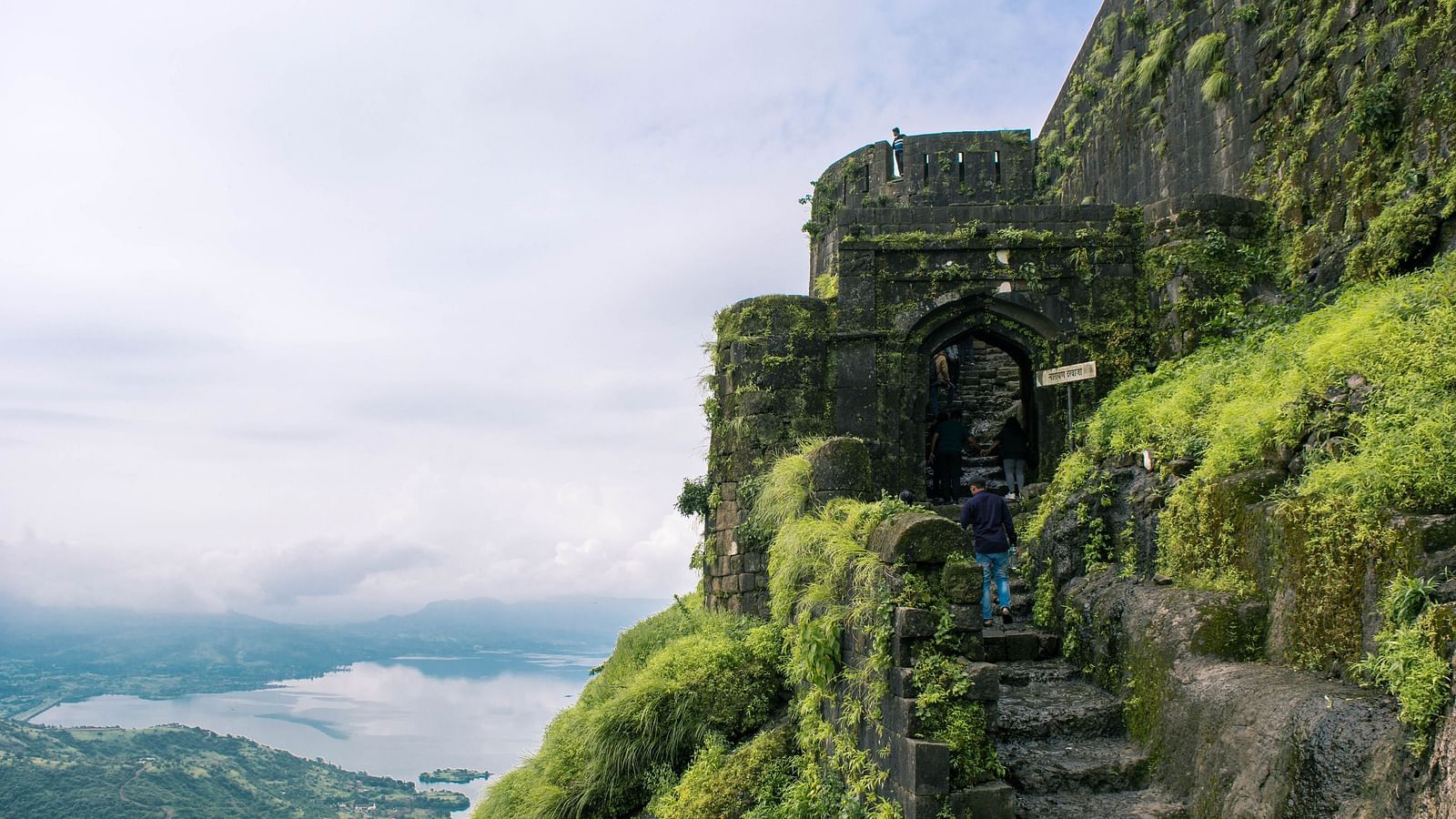 A steep staircase constructed from stone with a view of the valleys in the background