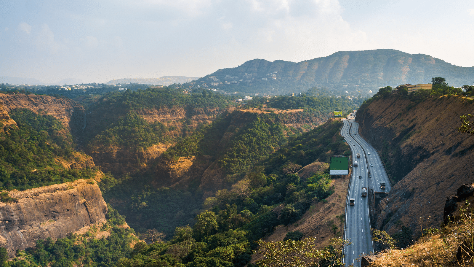 A bird's eye view of Khandala Ghat near Lonavala with a highway running parallel to the mountains
