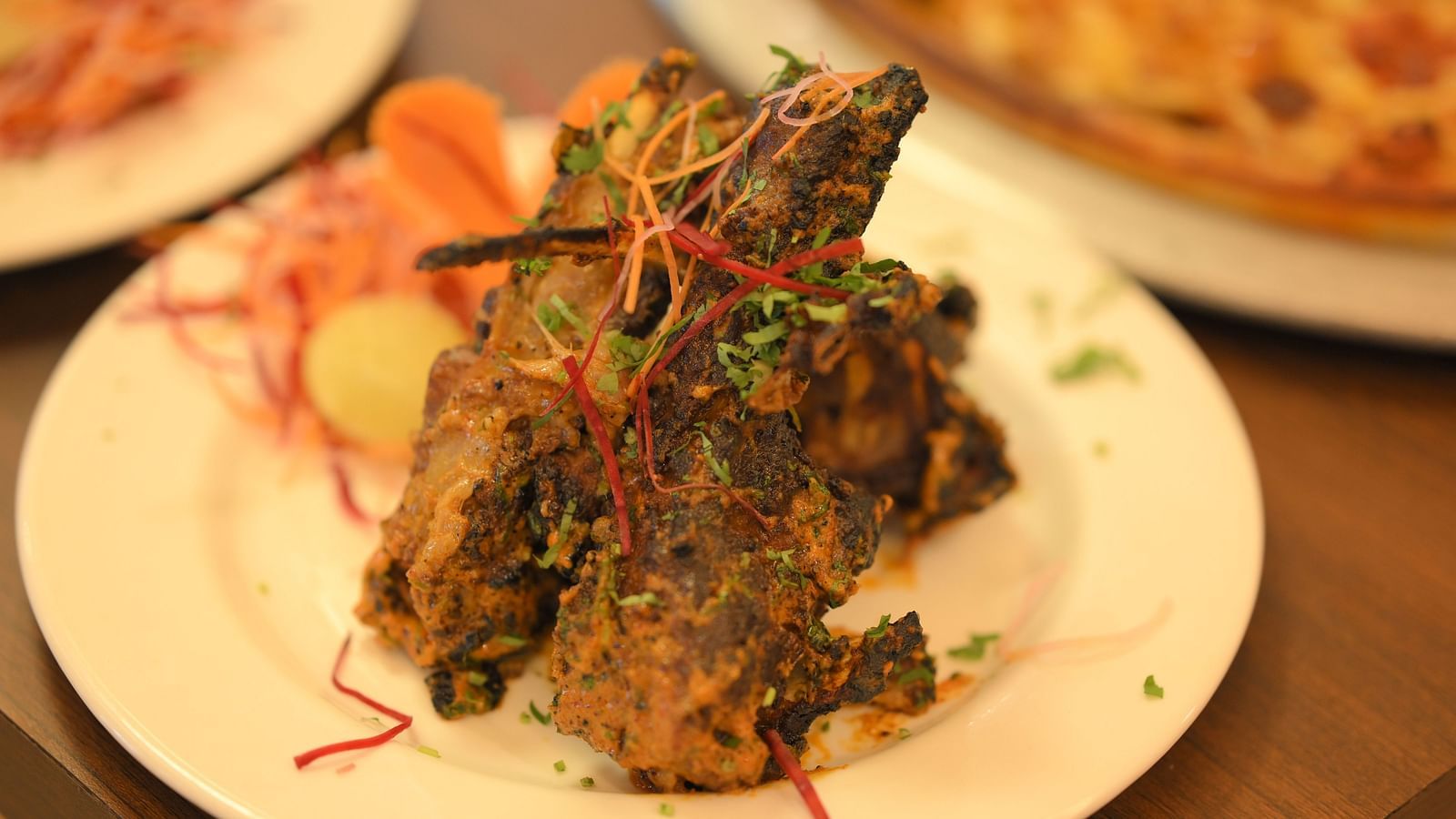 Crispy Indian starter garnished with herbs and spices, served hot at Royal Comfort Regency for an appetising beginning.