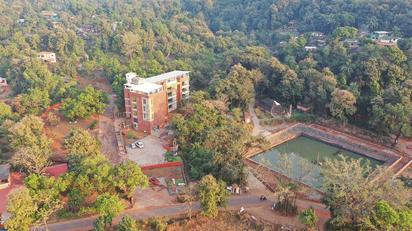 An aerial view of the resort with the facade of the building surrounded by trees and plants at SeaFort Beach Resort