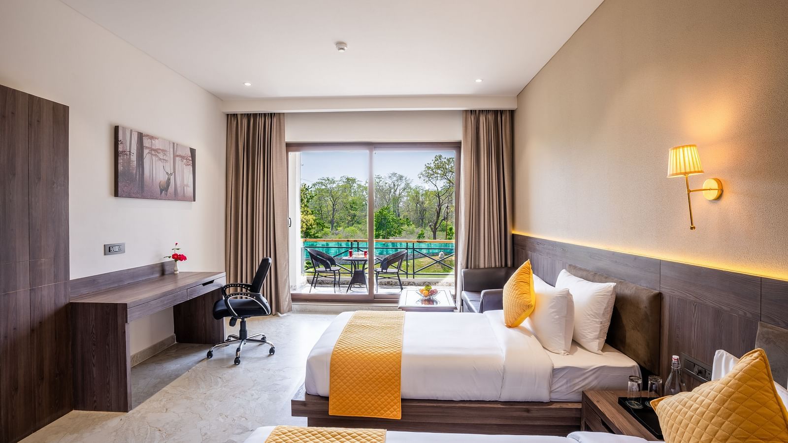 A hotel room with twin beds, ambient lighting and a balcony - Shervani Pebbles & Pines, Corbett