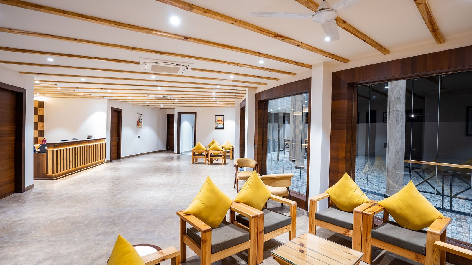 A reception area with a reception desk and comfortable furniture to sit and relax on - Shervani Pebbles & Pines, Corbett