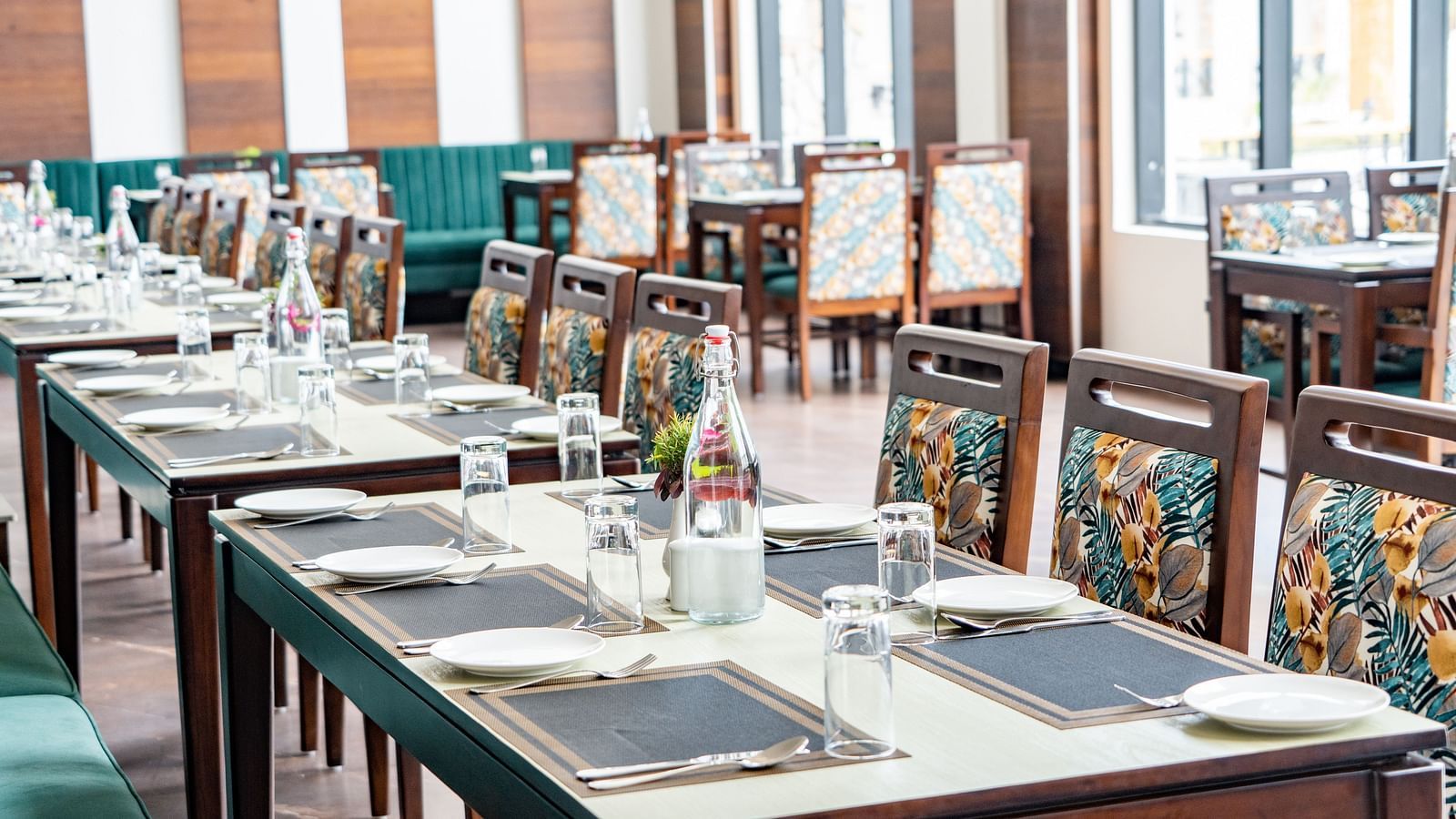 A close up shot of a long table with plates and cutlery in our restaurant - Shervani Pebbles & Pines, Corbett