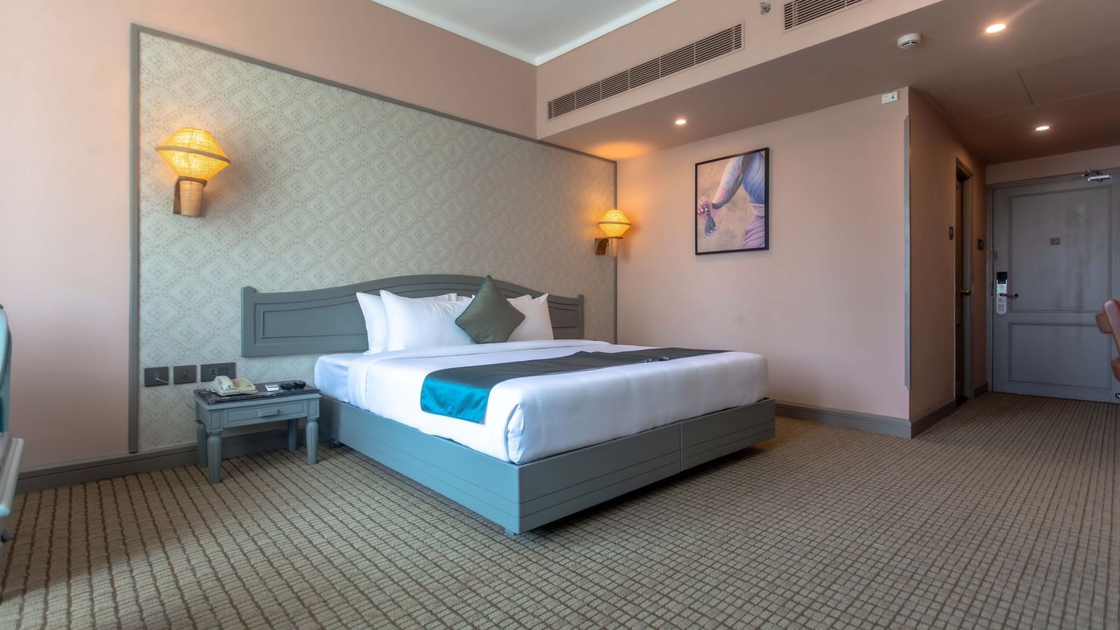  A contemporary guest room at Shilton International, Kochi featuring a large bed and tasteful furnishings.