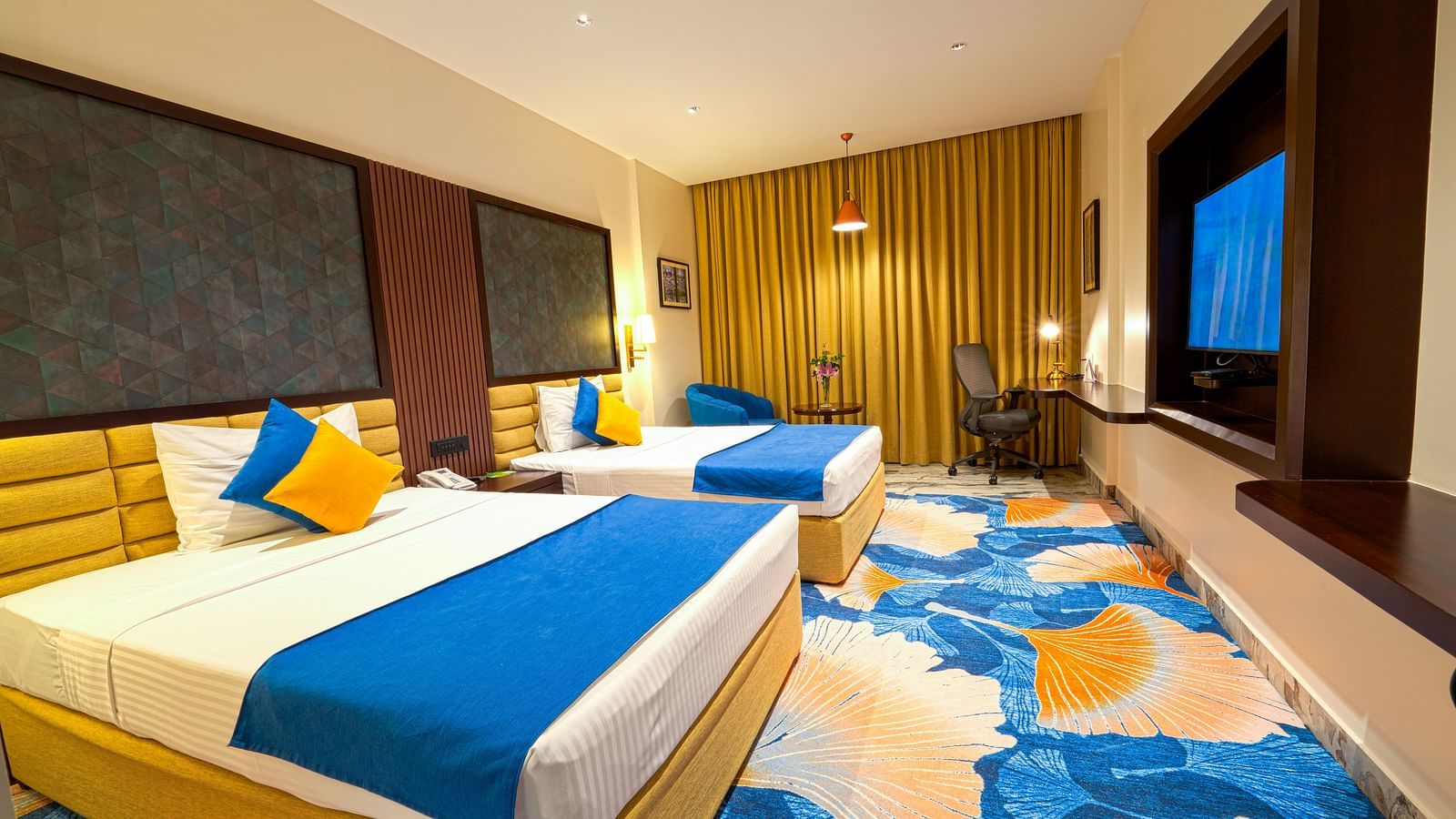 Room at Sitara Luxury Hotel in Hyderabad near Ramoji Film City with twin beds and a television