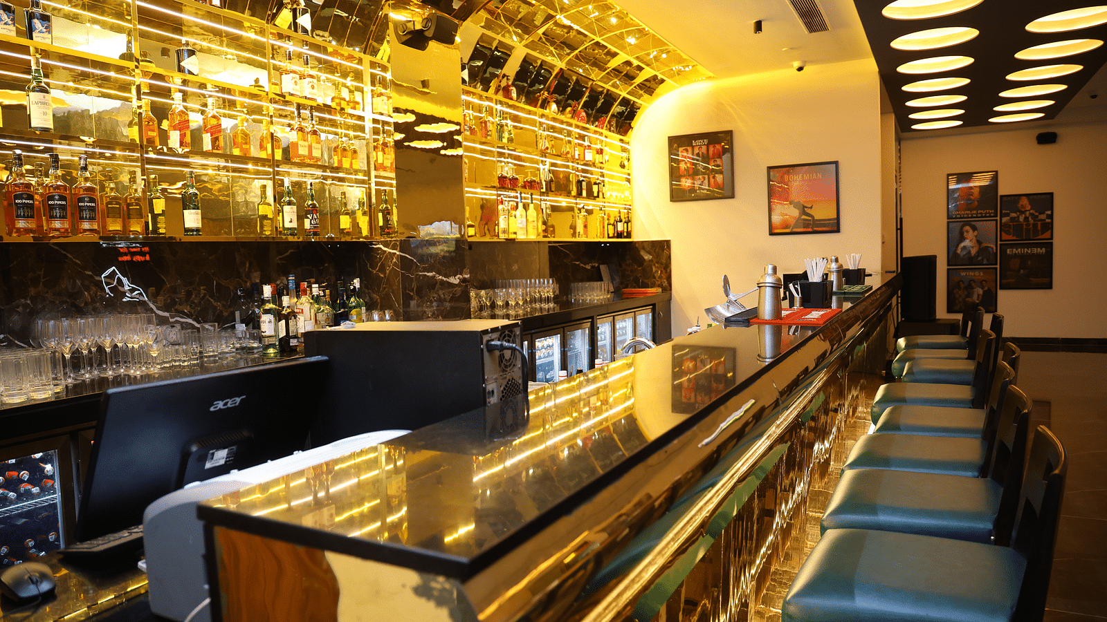 The bar at SRM Hotel Chennai, featuring a vibrant selection of cocktails and mixed drinks.
