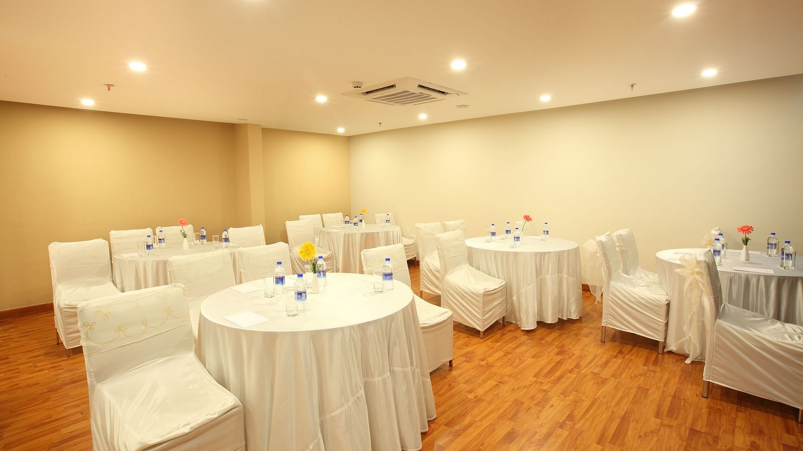 Round table seating inside the Banquet - Starlit Suites, Kochi