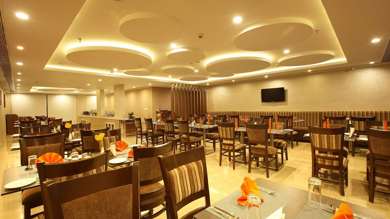 Seating arrangements inside the Gourmet Restaurant - Starlit Suites, Kochi
