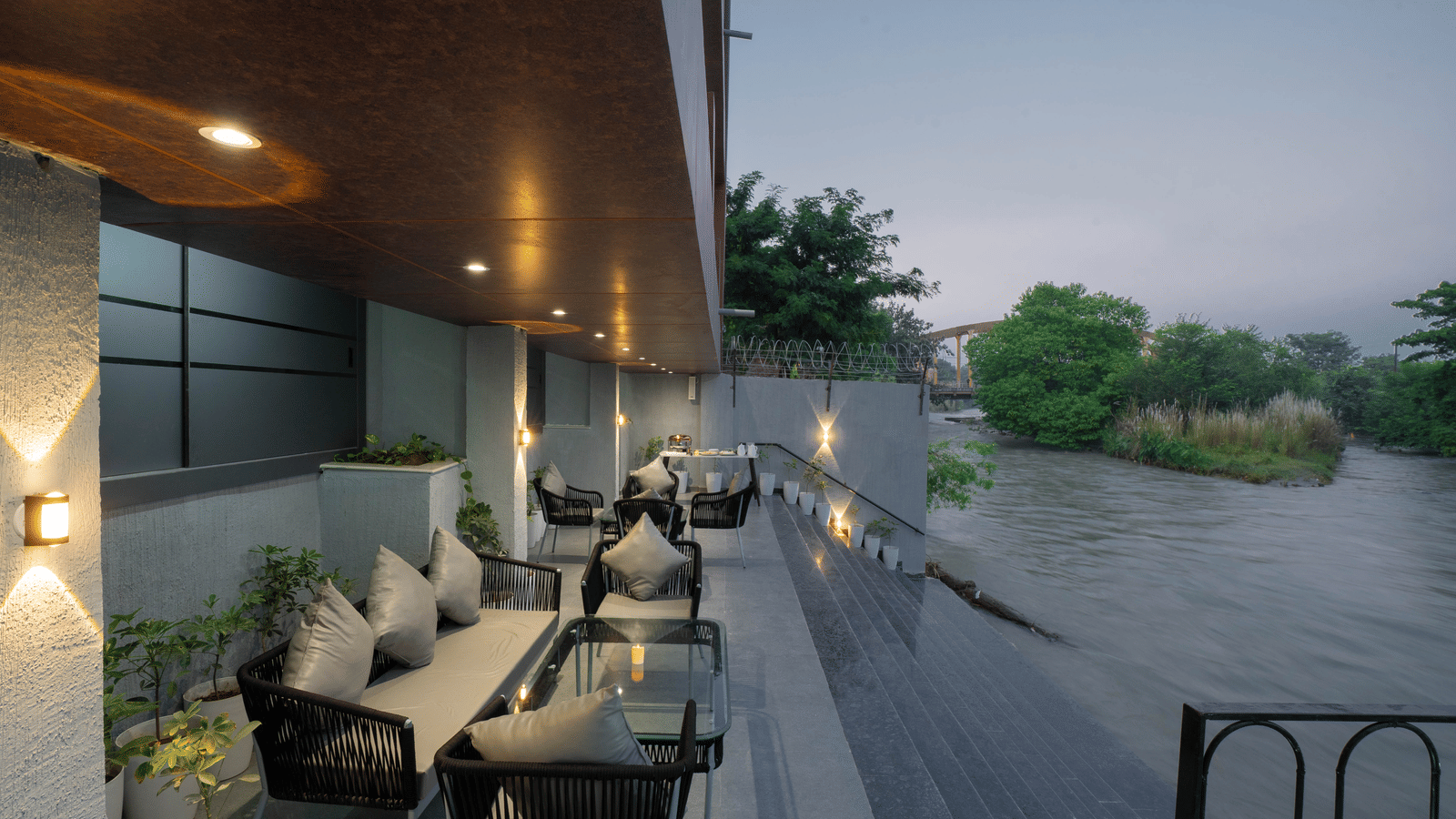 Comfortable outdoor seating area overlooking the river, perfect for relaxing at Sukoon by the Ganges.