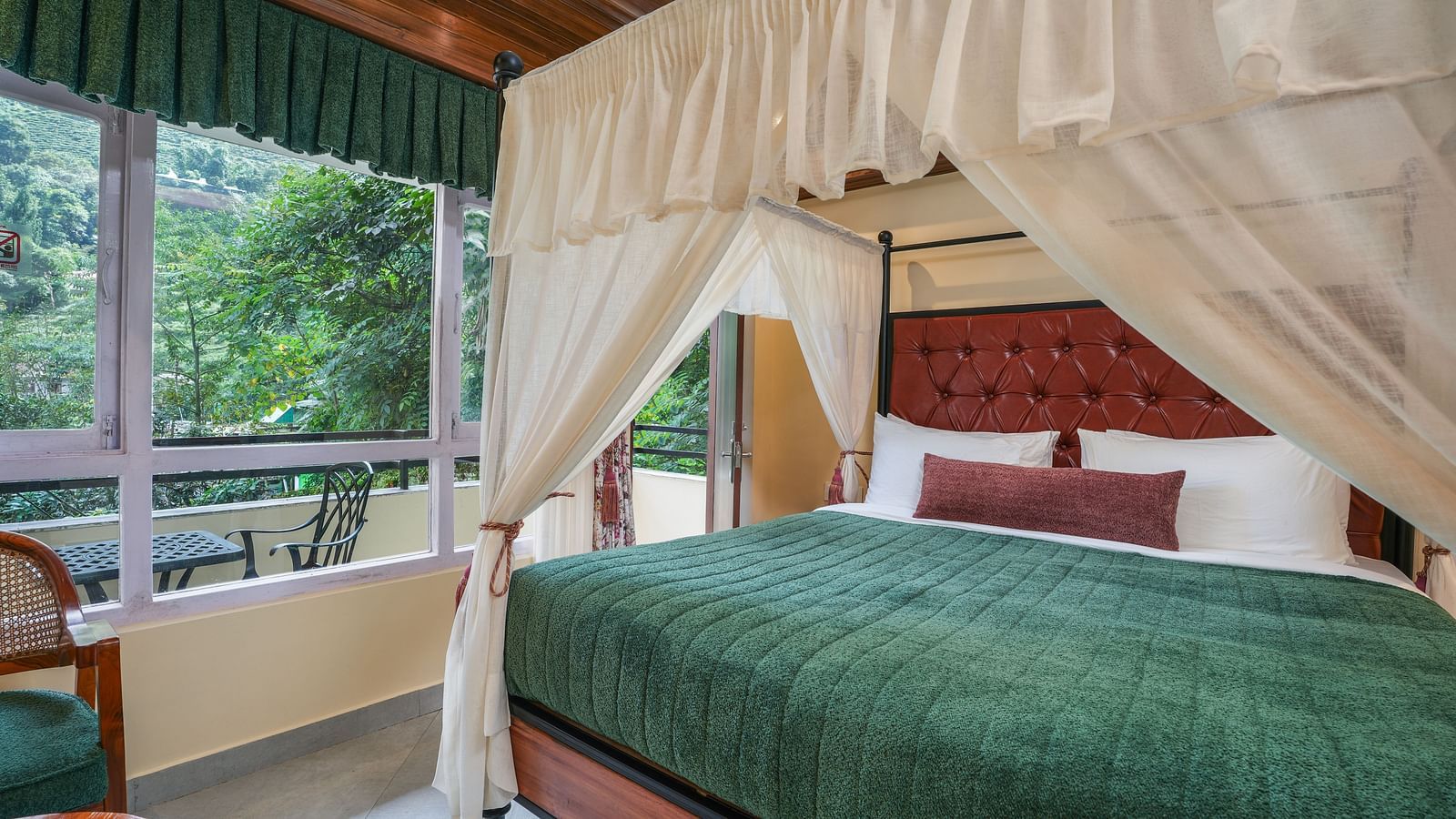 Premium Room with Balcony featuring a large bed with curtains neatly tied to rods on all four sides