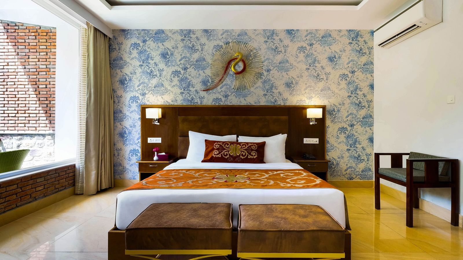 Bedroom with bed and sofa by the edge of the bed at Summit By The Ganges Beach Resort & Spa, Rishikesh