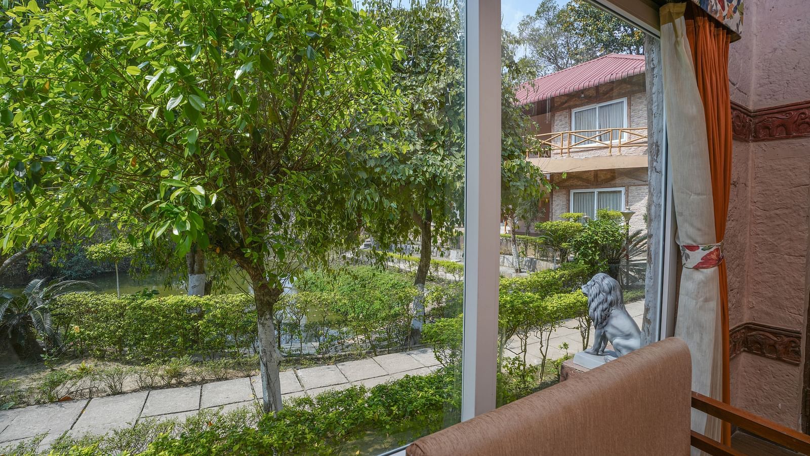 Duplex ethnic villa offering a stunning view through large windows at Summit Green Lake Tea Resort & Spa, Kaziranga