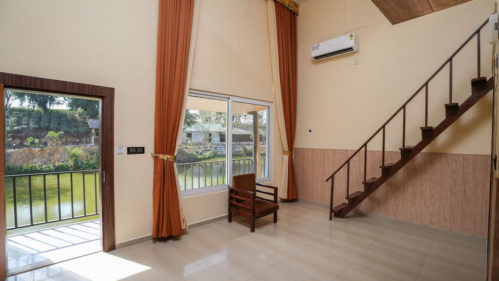 Duplex room with balcony features stairs leading to the spacious bedroom and lake view at Summit Green Lake Tea Resort & Spa, Kaziranga