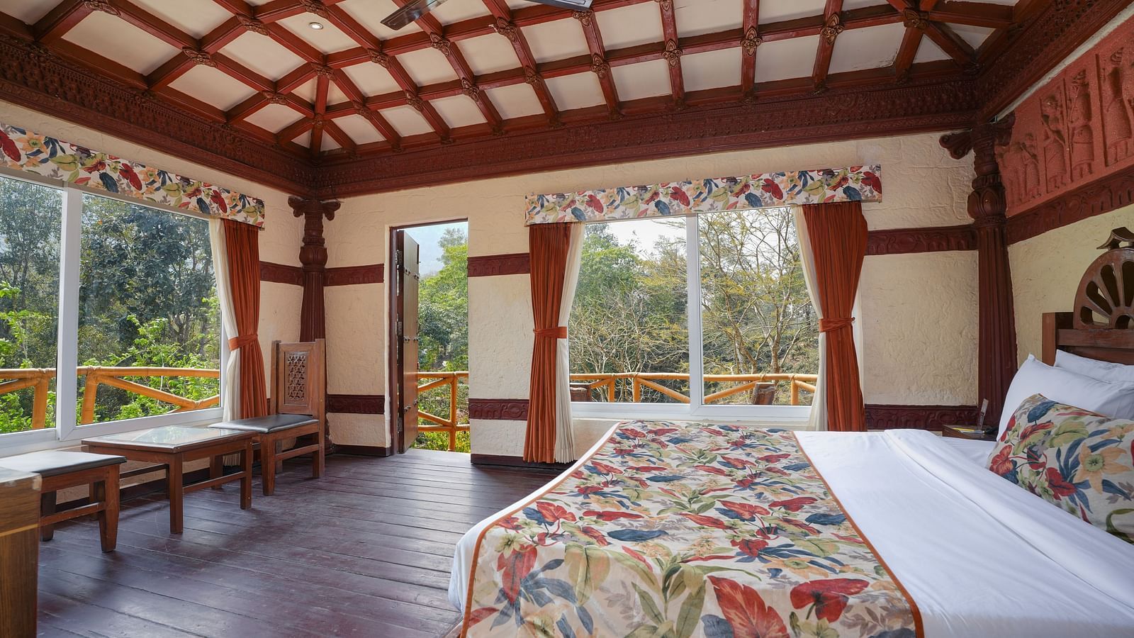 Ethnic villa featuring a spacious bed with wooden furniture and a wooden-framed ceiling at Summit Green Lake Tea Resort & Spa, Kaziranga