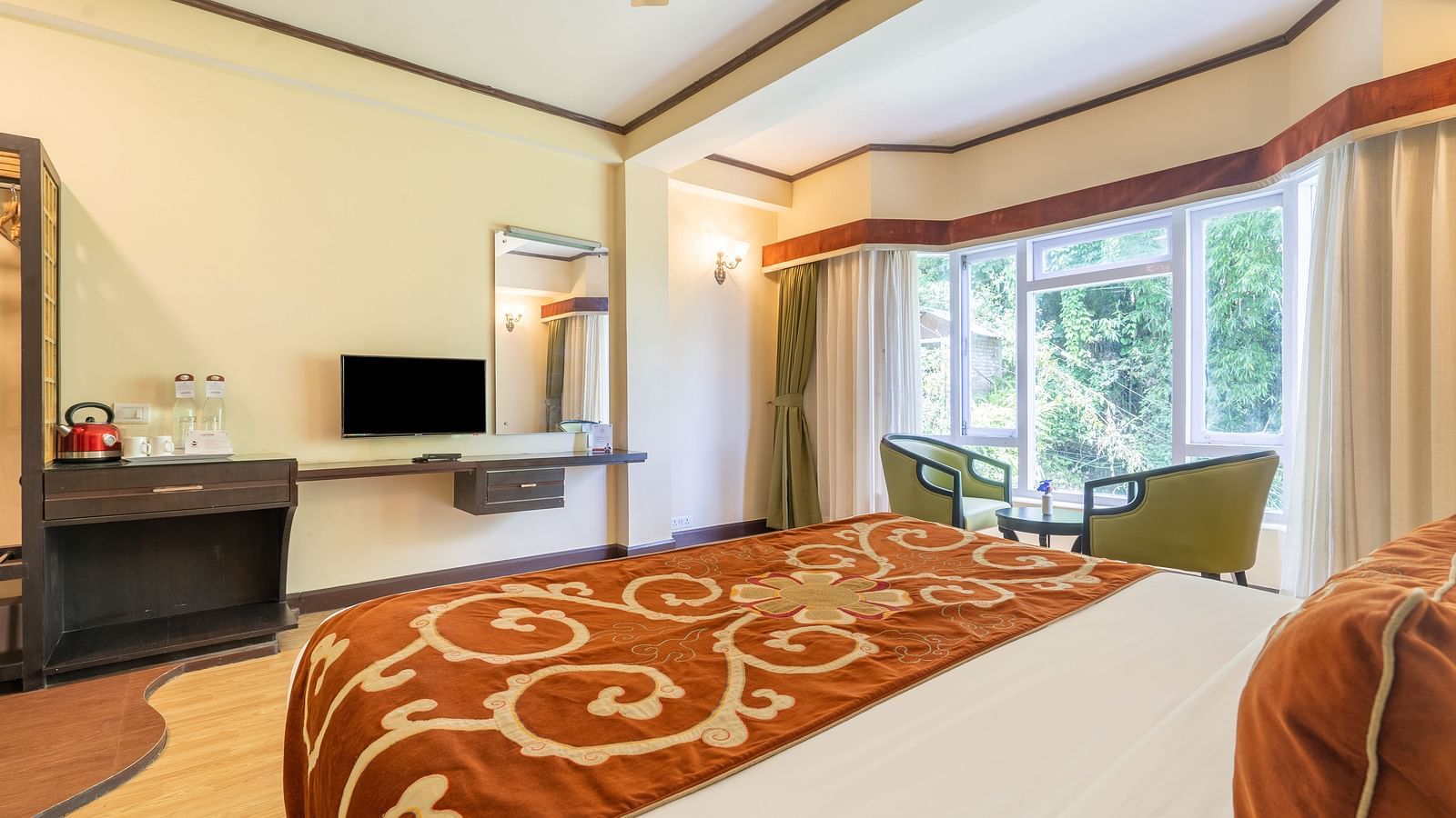king size bed and TV of deluxe bed at Summit Lillium Hotel & Spa, Kalimpong
