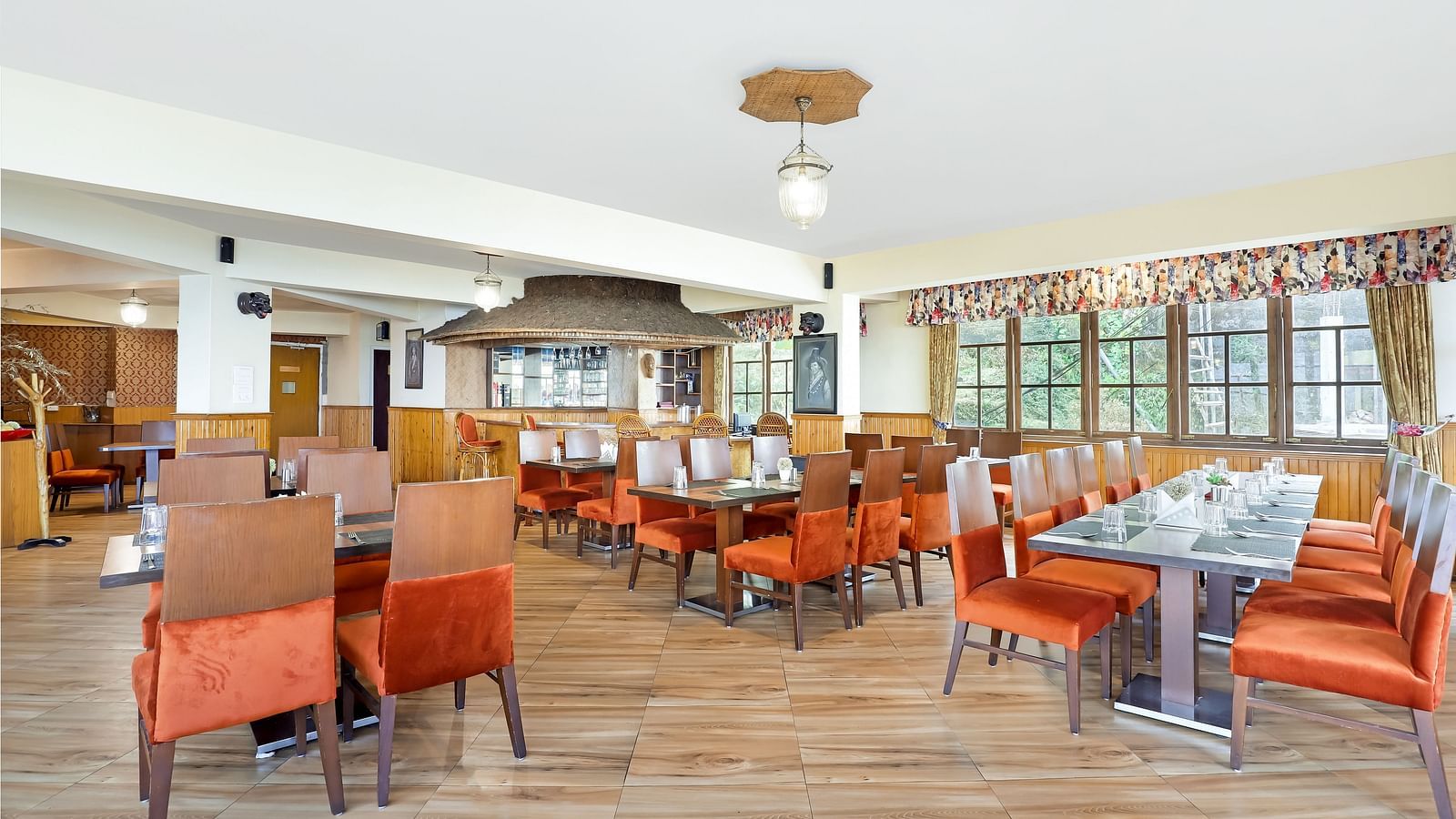 A full view of multiple dining tables and chairs placed in a closed hall | Summit Newa Regency & Spa, Pelling