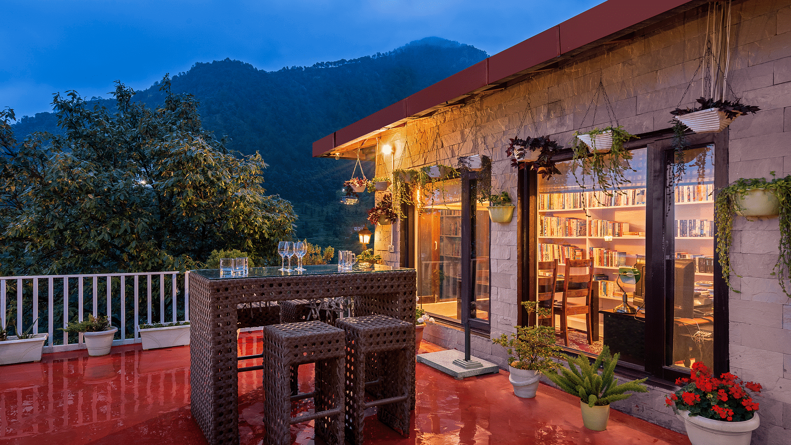 An image of a well lit cottage and outside it there is a courtyard with seating area - Suvaasa, Ramgarh