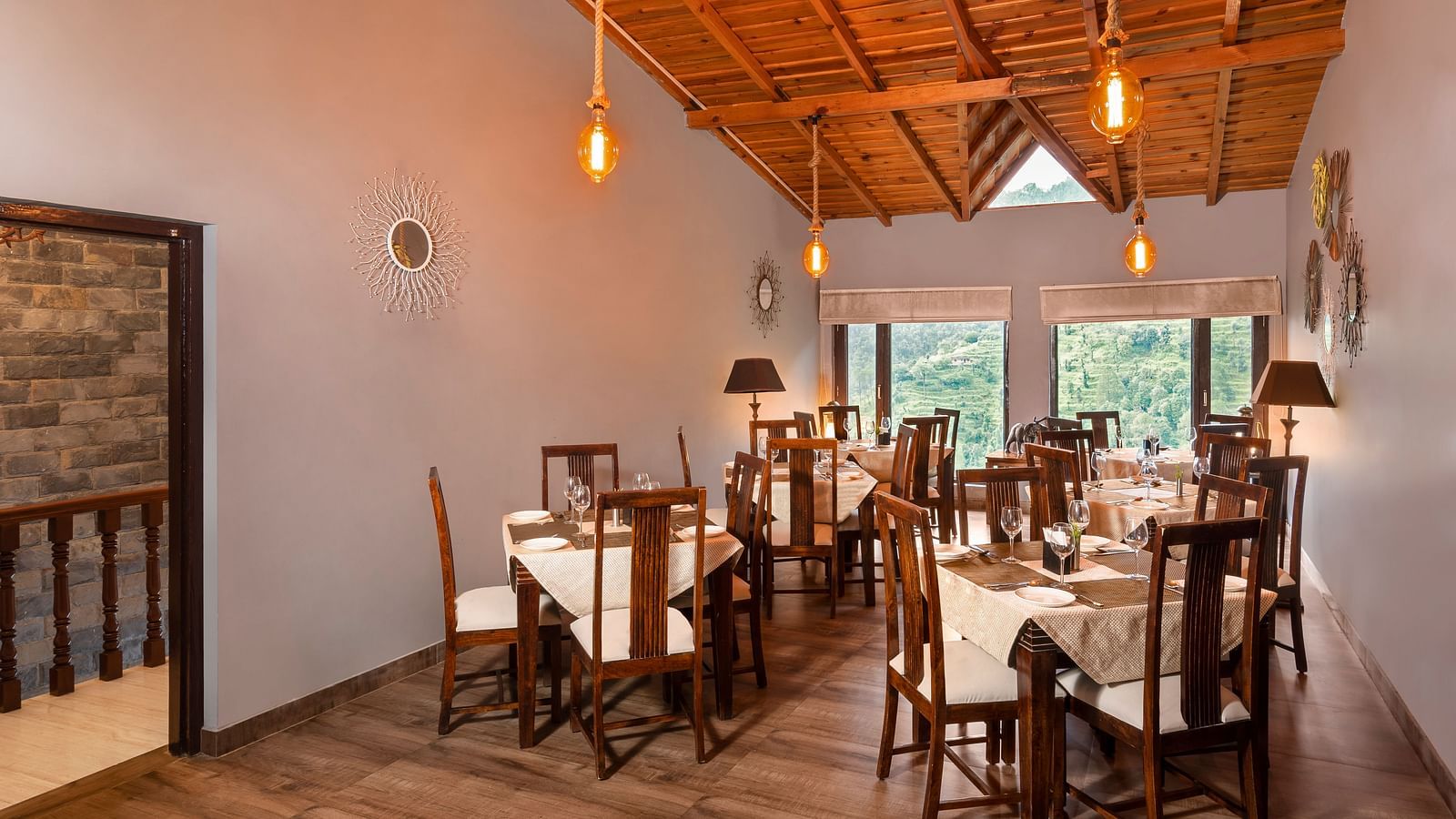 An image of a dining area with several wooden chairs and tables -Suvaasa, Ramgarh