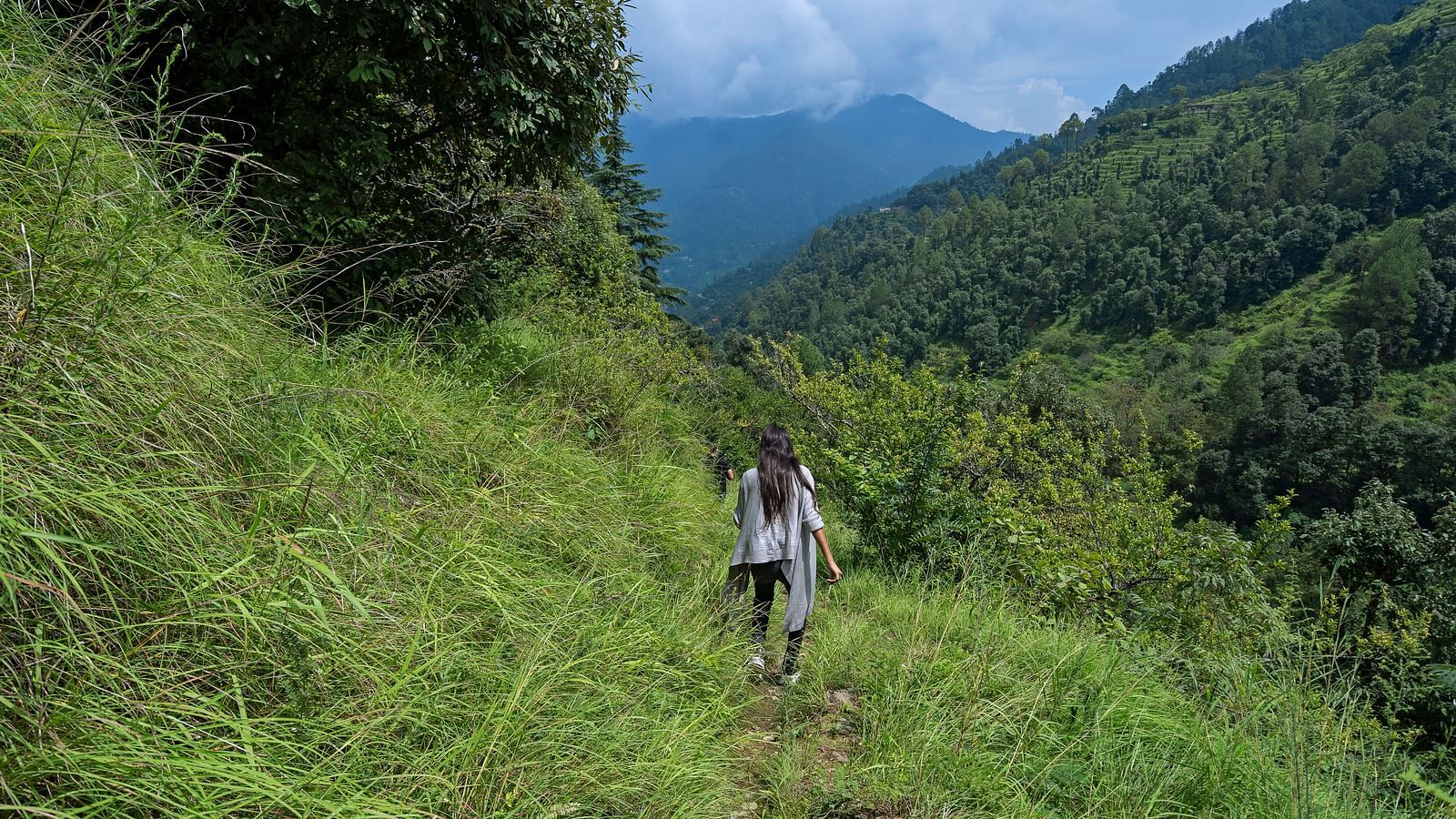 An image of two people trekking in a mountain 