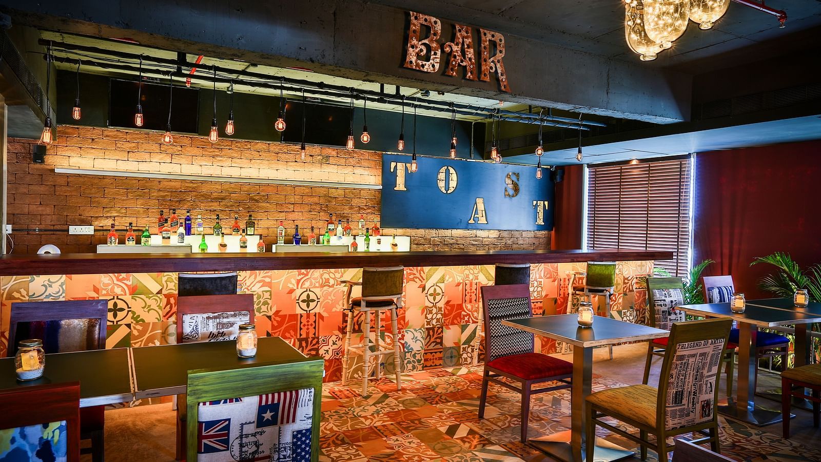 Indoor seating in the restaurant at T24 Residency, Andheri East, Mumbai in front of the bar counter area