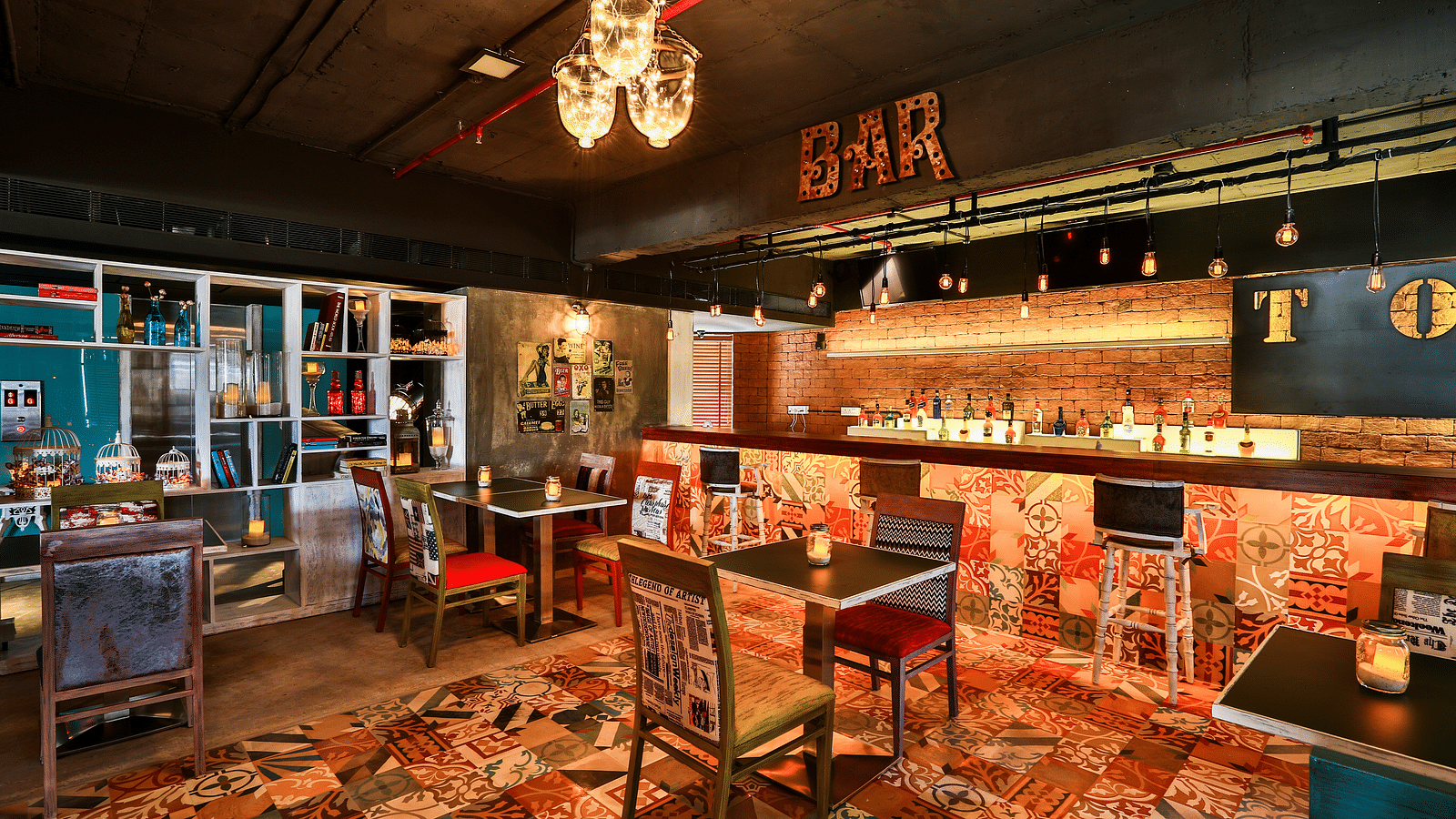 Indoor seating in the restaurant at T24 Residency, Andheri East, Mumbai with a bar counter in the backdrop