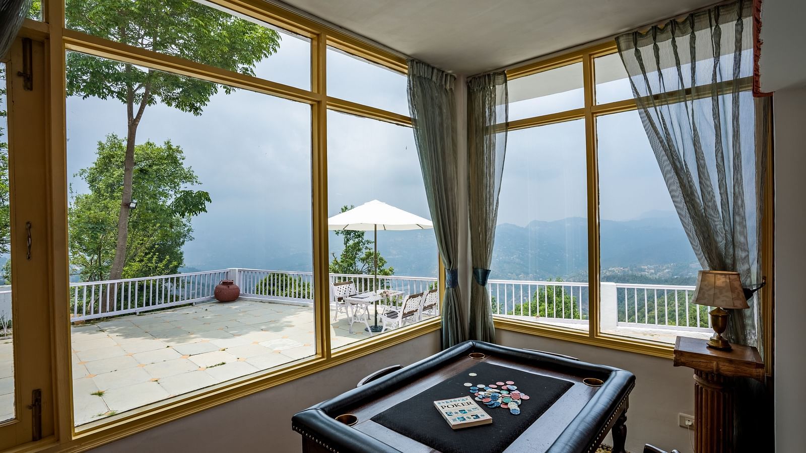 Side view of a room with large windows at Te Aroha By Shervani, Mukteshwar