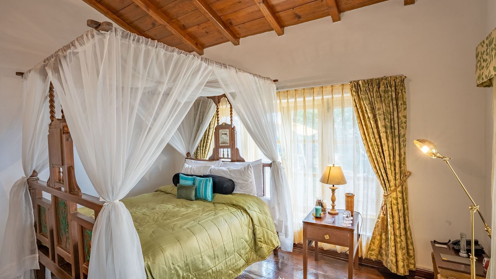 A bed with canopy inside one of the rooms at Te Aroha By Shervani, Mukteshwar